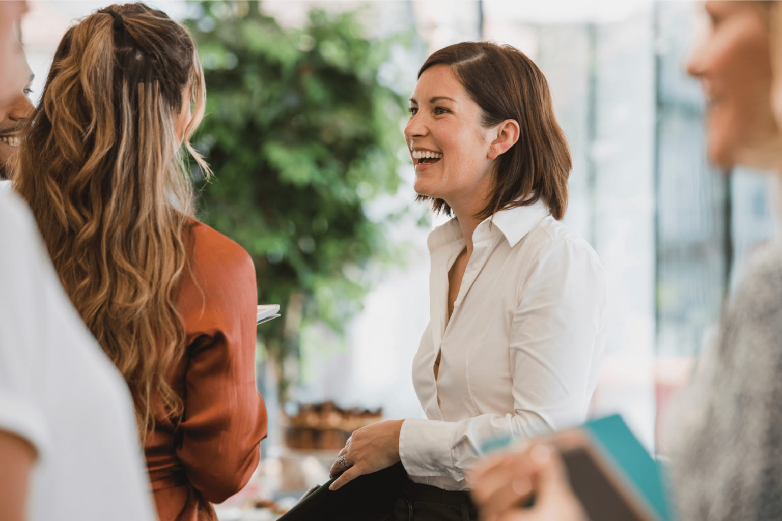 Women smile and engage in a supportive group discussion as part of borderline personality disorder treatment.