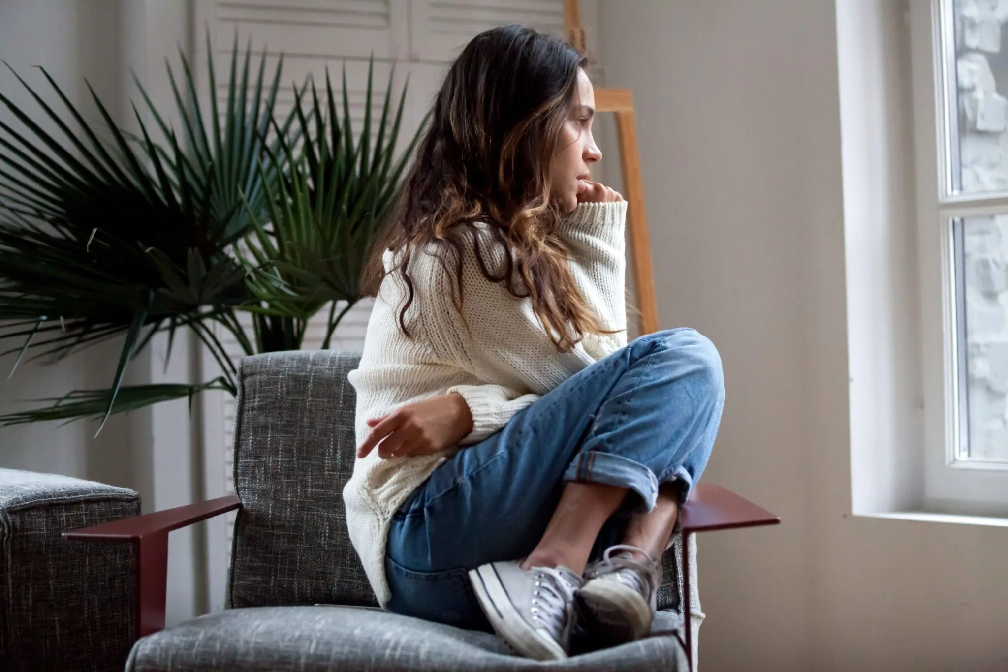 A woman with schizophrenia sitting in an office waiting to speak to a therapist