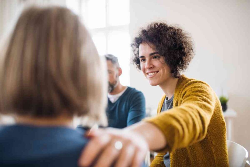People participating in a mental health support group discussion during therapy session