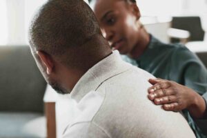 Mental health clinician offering support to a patient during an intake session